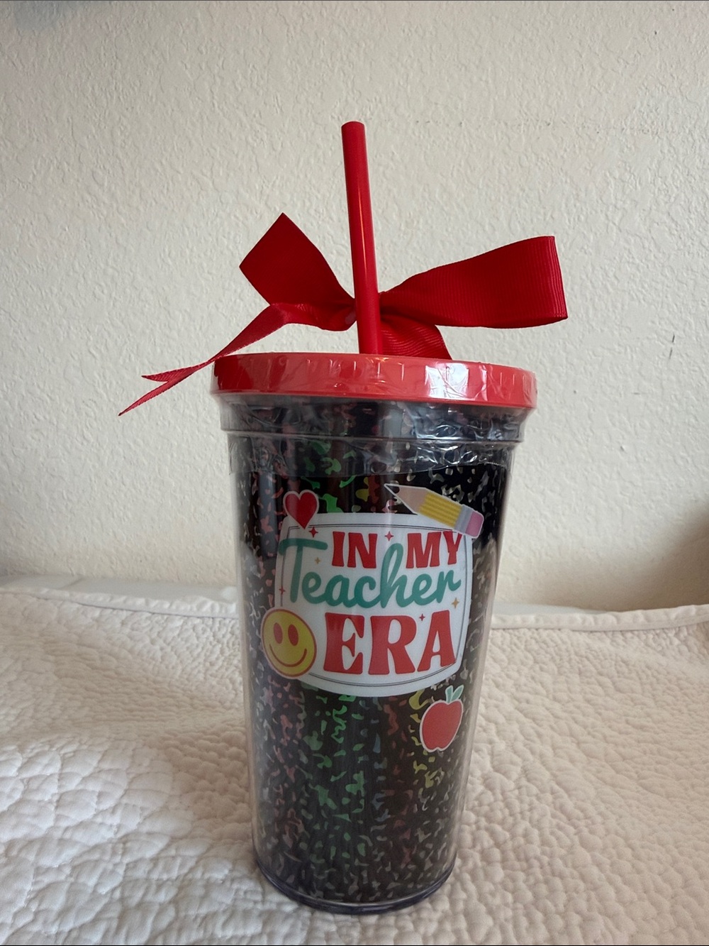 In My Teacher Era Red Tumbler Cup with Straw and colored highlighter markers.